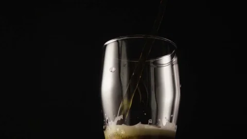 Dark beer is poured into a glass camera moves from top to bottom Stock Footage 72646681