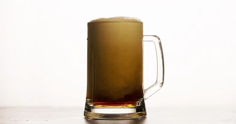 Dark Beer is pouring and foaming in Glass 4k Stock Footage 103645583