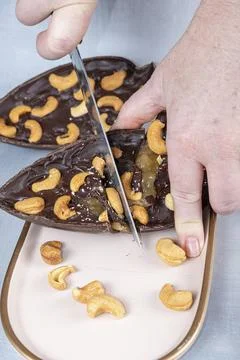 Dark Belgian chocolate Easter egg, filled with cupuau jam and cashew nuts 3.. Stock Photos