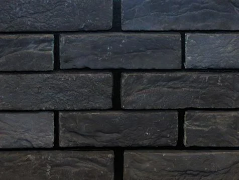 Dark black bricks construction material pattern background Stock Photos
