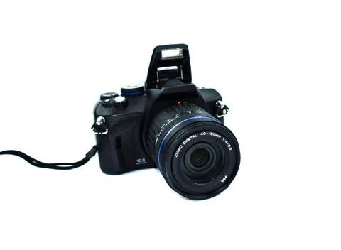 Dark black colored digital camera with lens attached to it placed on a white Stock Photos
