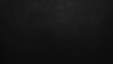 Dark black linen fabric texture panning smoothly under soft cinematic studio lig Stock Footage 337025646
