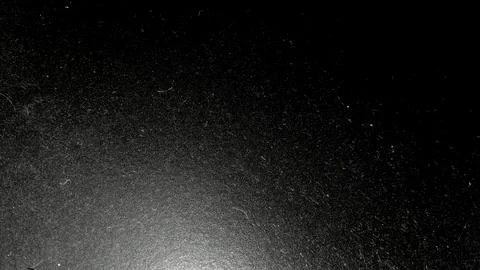 Dark black surface with fine dust particles and light scratches Stock Photos