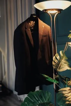 Dark blazer hangs elegantly on a hanger Fotos de archivo