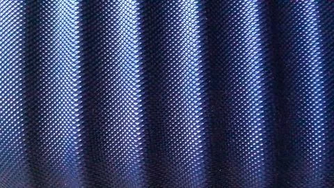 Dark blue abstract background featuring a wavy textured metallic surface Stock Photos