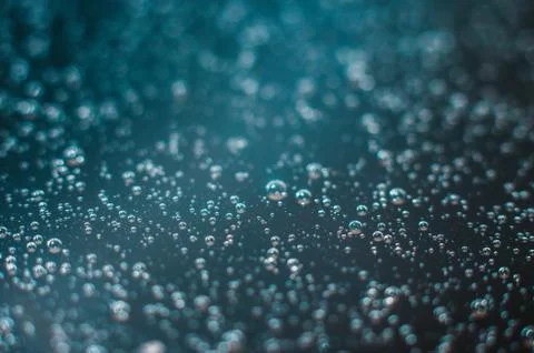 Dark blue background of air bubbles on the water surface Stock Photos