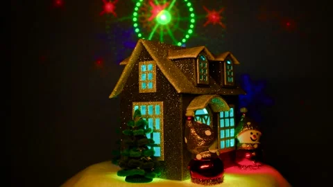 On a dark blue background a gray house with Christmas trees and snowmen nearby Stock Footage 312326825