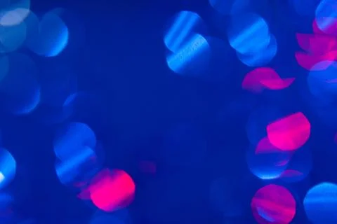 Dark blue background with light effects and white and pink lens flares Stock Photos