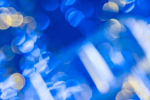 Dark blue background with light effects and white and yellow lens flares Stock Photos