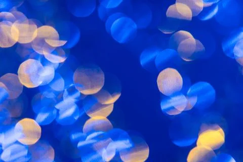 Dark blue background with light effects and white and yellow lens flares Stock Photos
