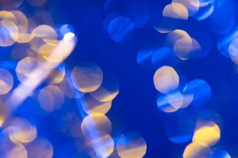 Dark blue background with light effects and white and yellow lens flares Foto stock