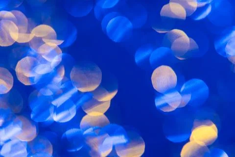 Dark blue background with light effects and white and yellow lens flares Stock Photos