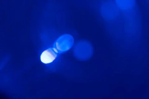 Dark blue background with light effects and lens flares Stock Photos