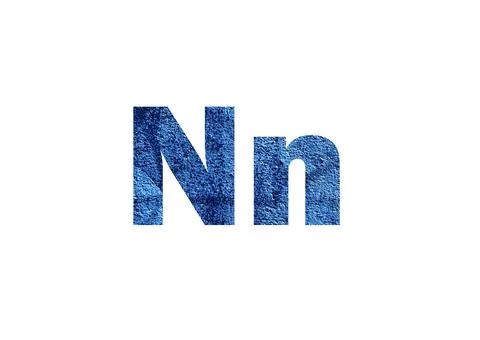 Dark blue background. Shot through the cut-out silhouette of the letter N Stock Photos