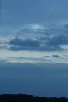 Dark blue cloudy sky background Stock Photos