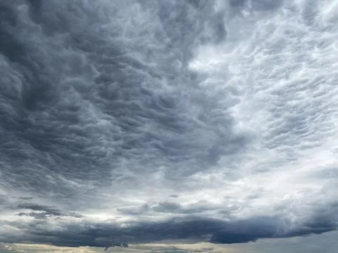Dark blue cloudy sky with low clouds Stock Photos