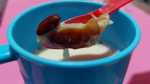 A dark blue cup filled with soybean milk. Stock Footage 277024782