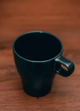 Dark blue cup on table Foto stock