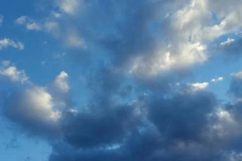 Dark blue evening sky with clouds. Blue hour. Heavenly natural background to  Stock Photos