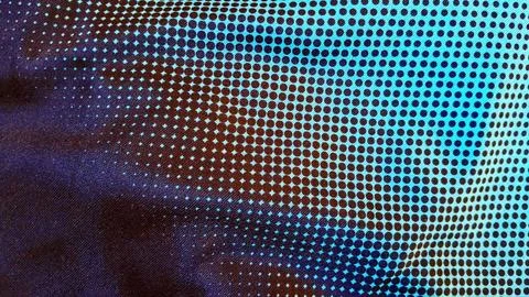 Dark blue fabric texture featuring a repeating black dotted halftone pattern Stock Photos