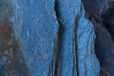 The dark blue, glossy surface of the stone. Abstract natural macro pattern. Stock Photos