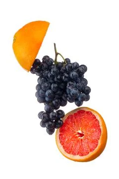 Dark blue grape with red grapefruit isolated on white background Stock Photos