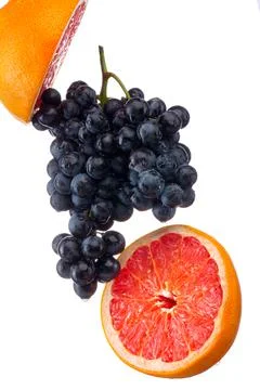 Dark blue grape with red grapefruit isolated on white background Stock Photos