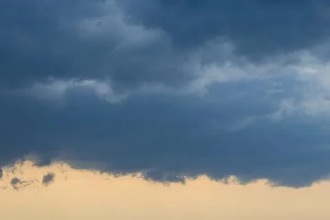 Dark blue heavy storm clouds before a thunderstorm or hurricane. Dramatic c.. Stock Photos