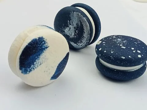 Dark blue macarons on white background Stock Photos