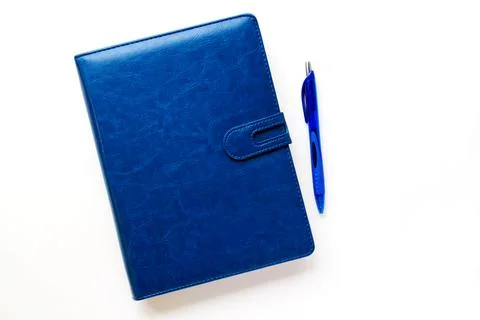 Dark blue notebook in a leather case on a light background. Stock Photos