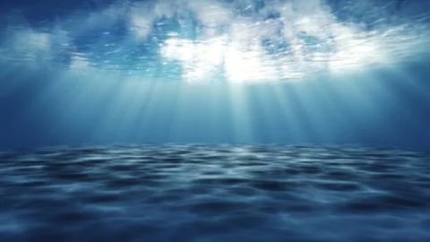Dark blue ocean surface from underwater. Stock Photos