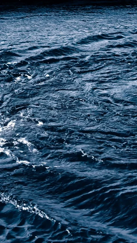 Dark blue ocean waves in slow motion with rich texture and movement. Vertical 4K Stock Footage 307012497