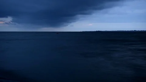 Dark blue rainy clouds move over water Video stock 69761278