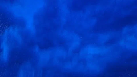 Dark blue rainy sky texture with falling raindrops overlay Stock Photos