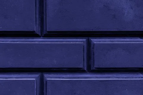 Dark blue rusticated wall texture with rectangular blocks and deep grooves .. Stock Photos