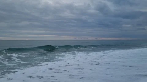 Dark Blue Sea Waves Under Dramatic Cloudy Sky at Sunset Stock Footage 320253738