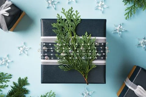 Dark blue square gift box decorated with a cedar branch and transparent bea.. 스톡 사진