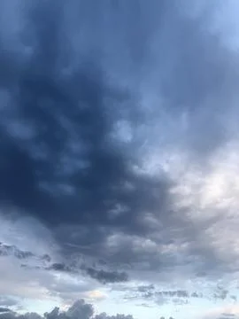 Dark Blue Storm Clouds Above Bright Horizon 写真素材