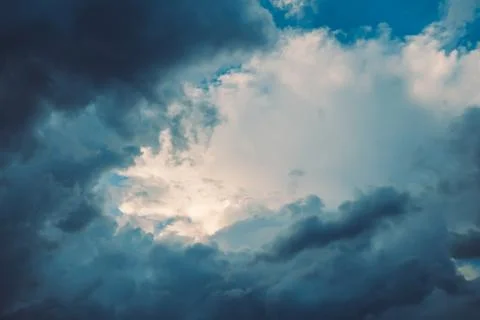 Dark blue stormy dramatic clouds in sky Stock Photos