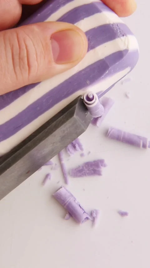 The dark blue striped soap is precisely cut into curls, detailed texture Stock Footage 310565117