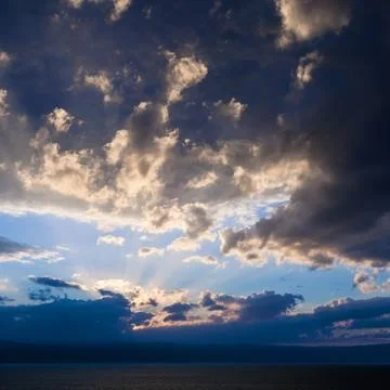 Dark blue sunset clouds over Dead Sea in winter Stock Photos