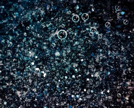 Dark blue texture background with bright white crystals. Stock Photos