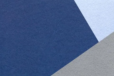 Dark blue textured paper background with light gray triangular corner and c.. Illustrazione stock