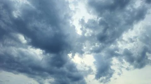 Dark blue thunder clouds in the sky, natural background Stock Photos