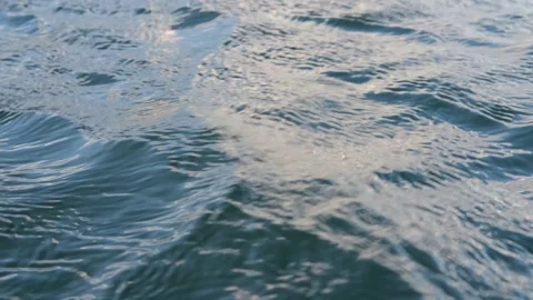 Dark blue water surface of a lake, sea, ocean with waves, ripples and sun glare Stock Footage 240626530
