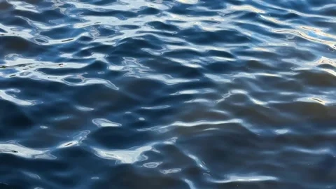 Dark blue water surface with ripples and light reflection Stock Footage 317629757