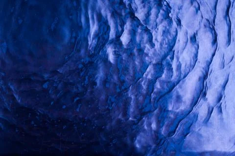 Dark blue water surface texture with ripples and splashes. Abstract summer ba Stock Photos