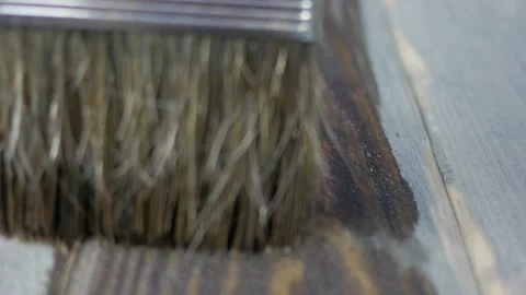 Dark board staining with clear varnish. Macro paint brush Stock Footage 143420348