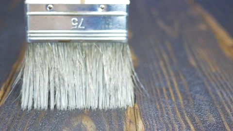 Dark board staining with transparent varnish. Macro paint brush Stock Footage 143420331