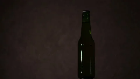 Dark bottle and blinking light on the background 4K Stock Footage 147057960